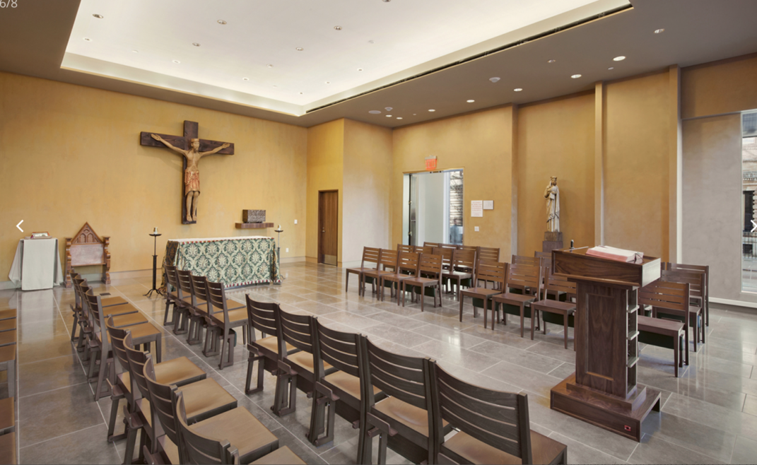 A crucifix hanging in the background of a chapel.